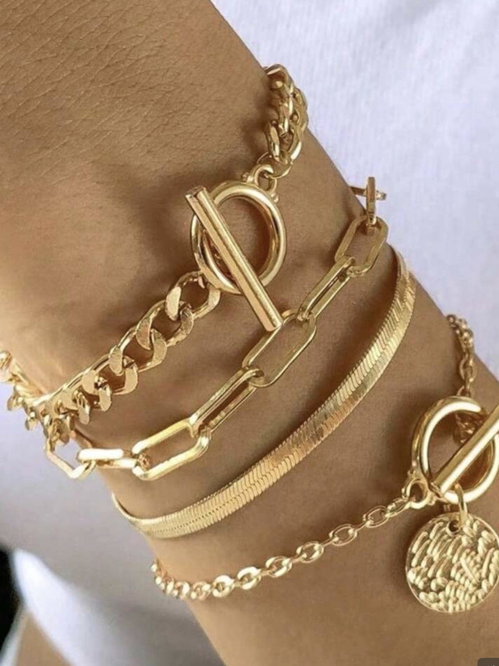 Delicate Gold Layered Bracelet Set with Toggle Accents.